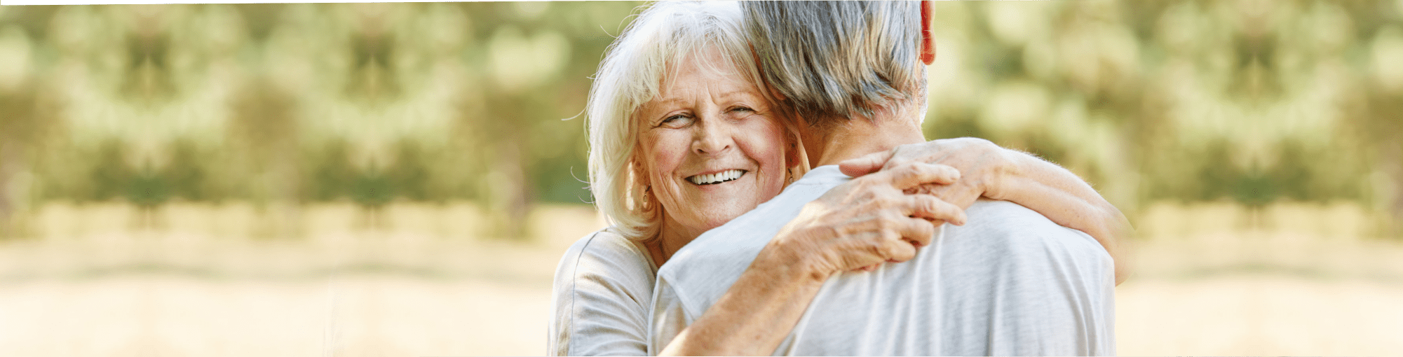 elderly couple hugging