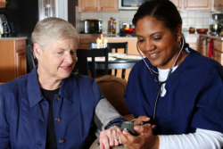 elderly woman having her blood pressure checked